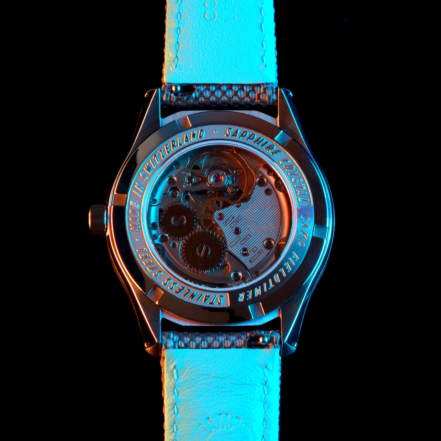 Close-up photo showing Sellita hand-wound movement of the blue Camp Fieldtimer mechanical luxury Swiss Made vintage inspired dress field watch for men and women with colorful lacquer enamel dial designed in Los Angeles, California