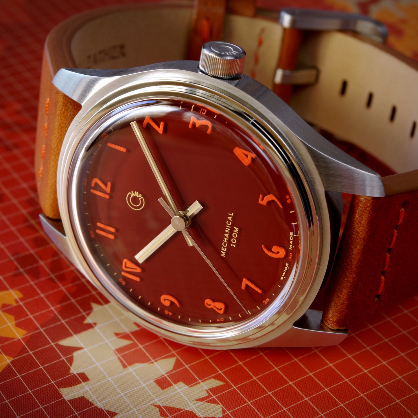 Close up of Camp Fieldtimer Swiss Made mechanical watch with 39mm deep red enamel lacquer dial and Italian leather strap for men and women designed by Camp Watches in Los Angeles.